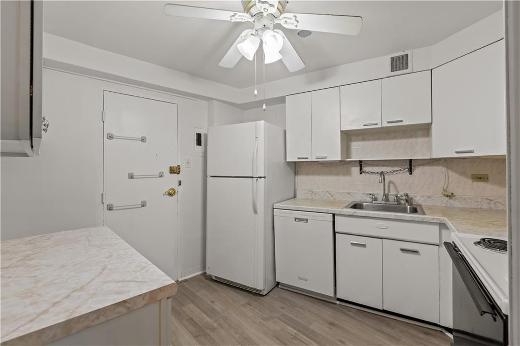 4625 Fifth Avenue, Unit 209 Pittsburgh, PA 15213 - Photo 13 of 23 a kitchen with a refrigerator sink and cabinets