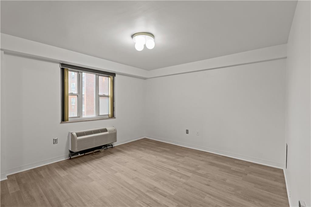 4625 Fifth Avenue, Unit 209 Pittsburgh, PA 15213 - Photo 18 of 23 an empty room with wooden floor and windows