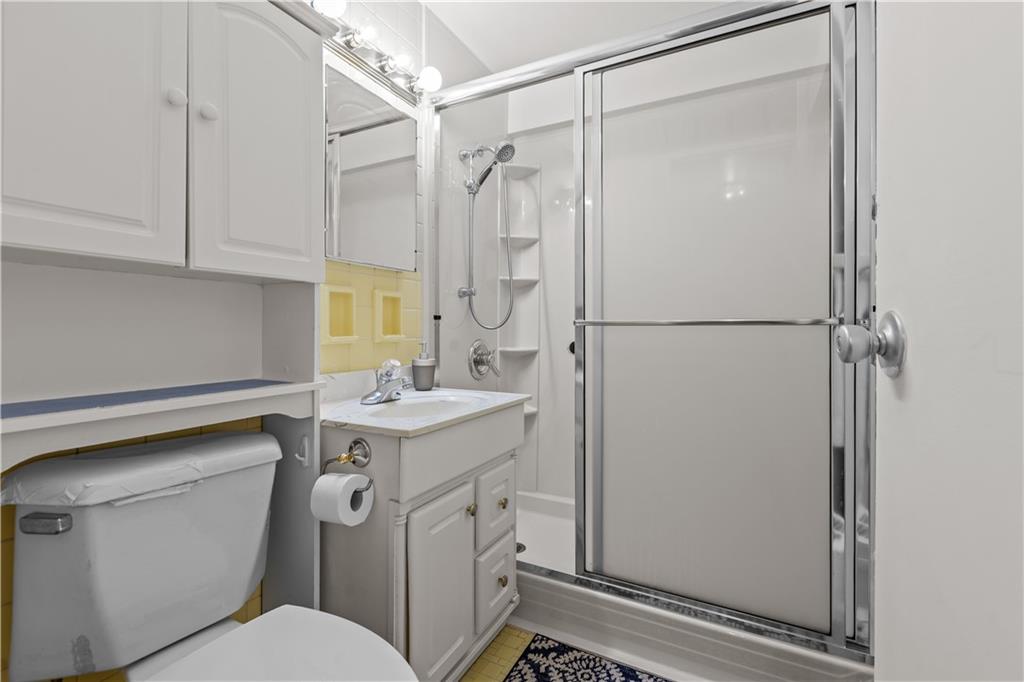 4625 Fifth Avenue, Unit 209 Pittsburgh, PA 15213 - Photo 20 of 23 a bathroom with a granite countertop sink toilet and shower