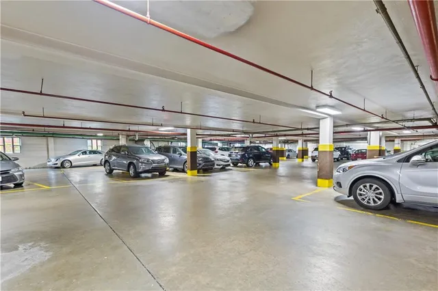 a view of parking garage with cars