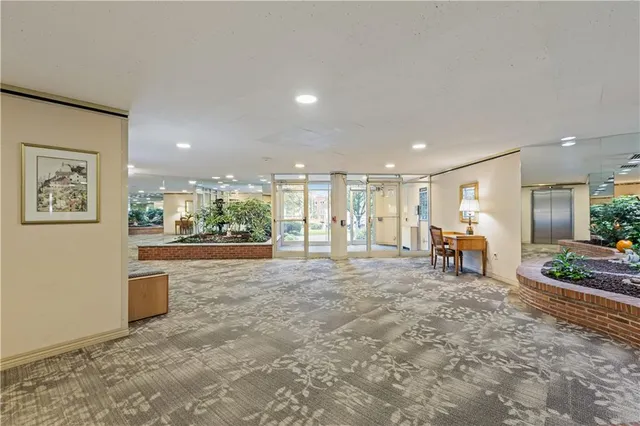 a view of a hallway with seating area