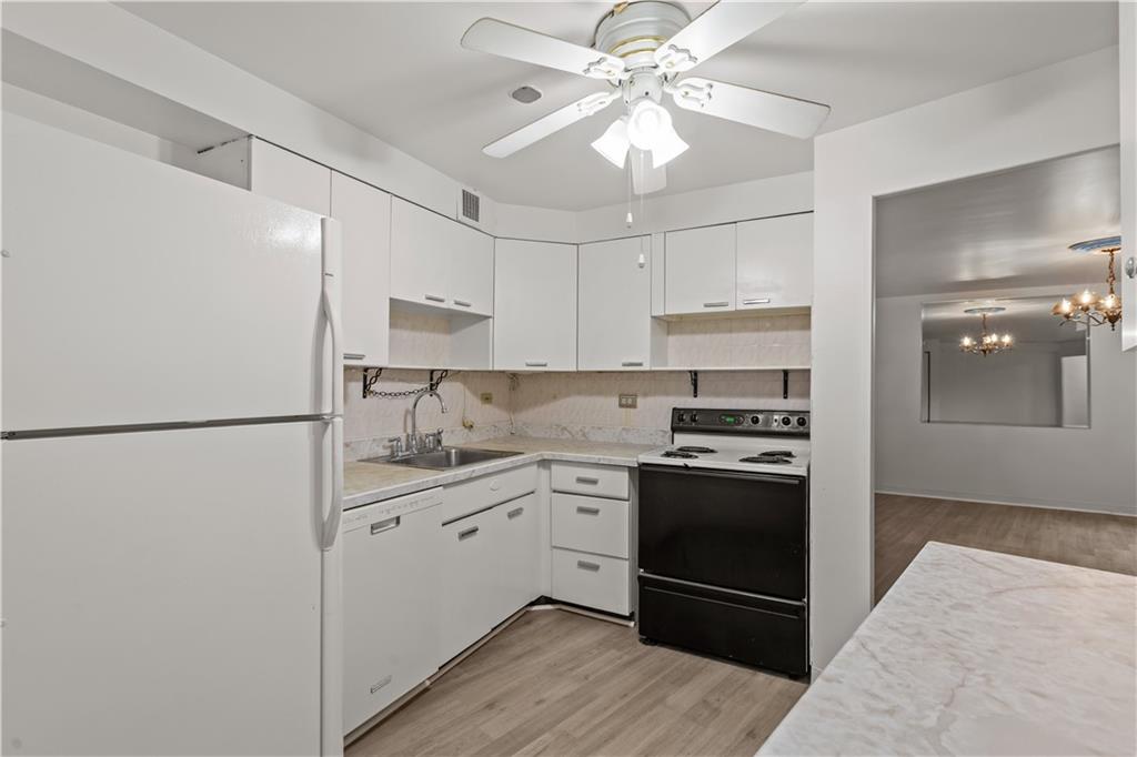 4625 Fifth Avenue, Unit 209 Pittsburgh, PA 15213 - Photo 5 of 23 a kitchen with stainless steel appliances granite countertop a refrigerator a sink a stove and white cabinets