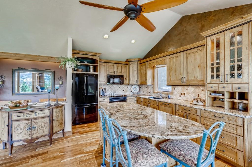 72 Aa Road Silverthorne, CO 80498 - Photo 11 of 28 a large kitchen with granite countertop lots of counter space and stainless steel appliances