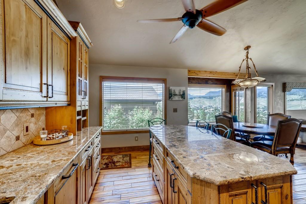 72 Aa Road Silverthorne, CO 80498 - Photo 12 of 28 a kitchen with granite countertop a stove and a wooden floors