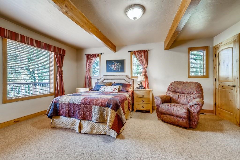 72 Aa Road Silverthorne, CO 80498 - Photo 14 of 28 a spacious bedroom with a bed and wooden floor