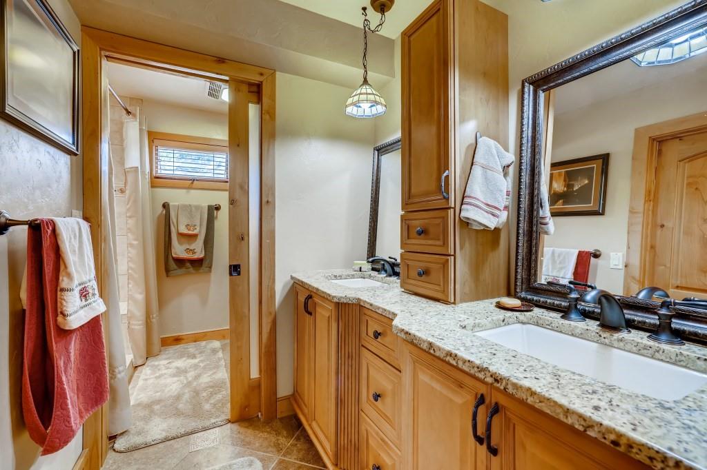 72 Aa Road Silverthorne, CO 80498 - Photo 16 of 28 a bathroom with a granite countertop sink and a mirror