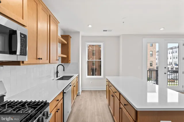 a kitchen with sink a stove and cabinets