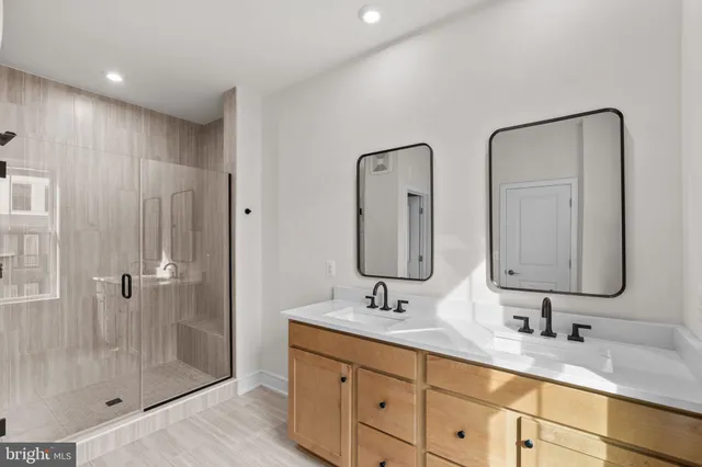 a bathroom with double vanity sinks double vanity and a shower