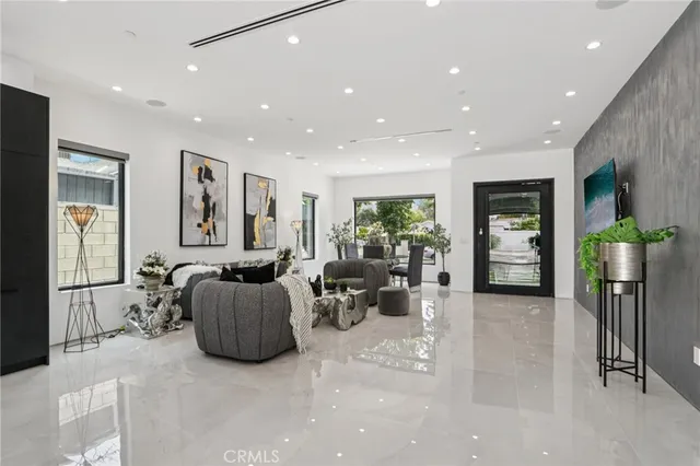 a living room with furniture and potted plant