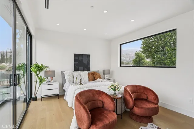 a bedroom with a large bed and a large window