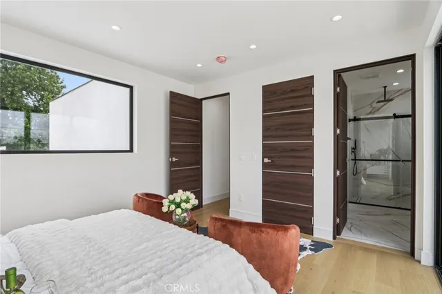 a spacious bedroom with a bed and a painting on the wall