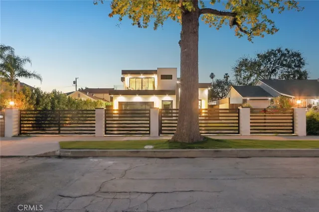 a view of a house with pool and sitting area