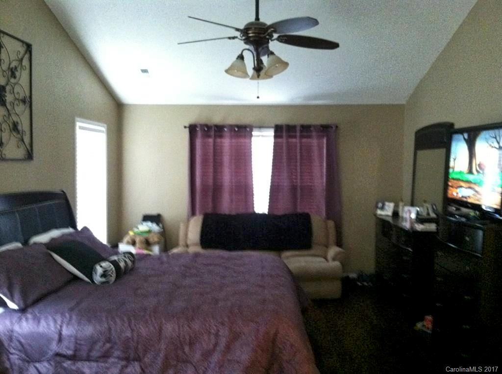 36 Wildbriar Road, Unit 2 Fletcher, NC 28732 - Photo 5 of 12 a bedroom with a bed dresser and a chandelier
