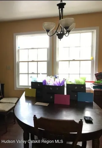 a view of hallway with stairs and a window