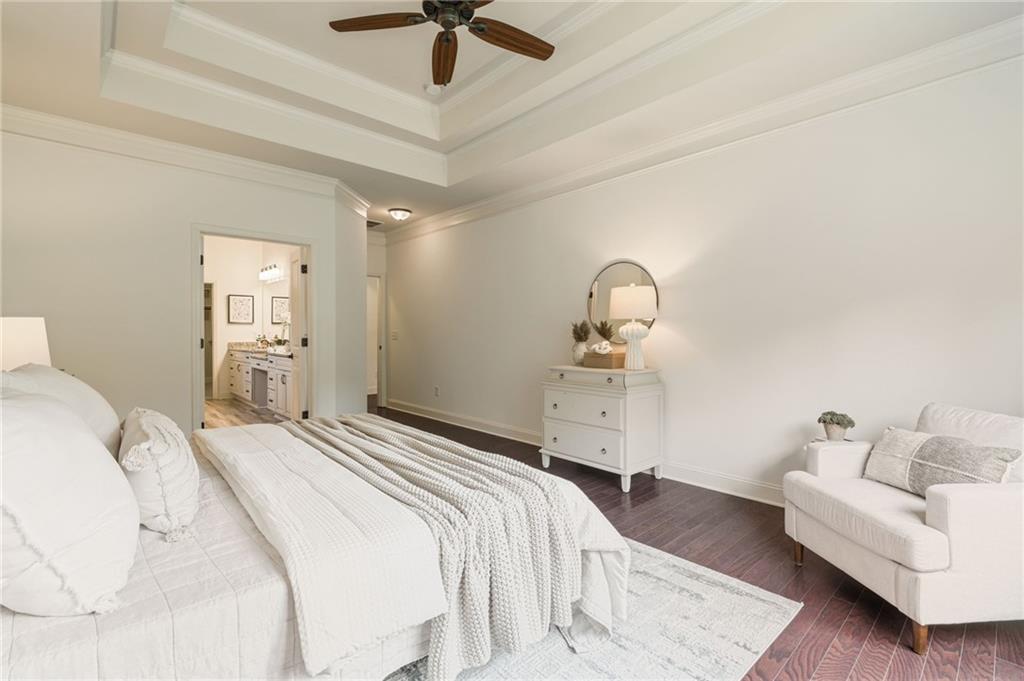 4735 Amble Trace Cumming, GA 30040 - Photo 43 of 73 a bedroom with a bed ceiling fan and a wooden floor