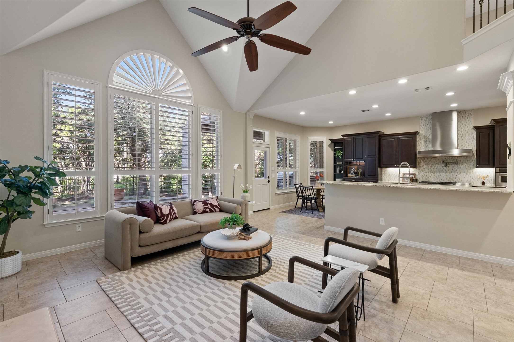8215 Dark Ridge Cove Austin, TX 78737 - Photo 11 of 40 Natural light pours into the main living space with soaring ceilings and a gourmet kitchen.