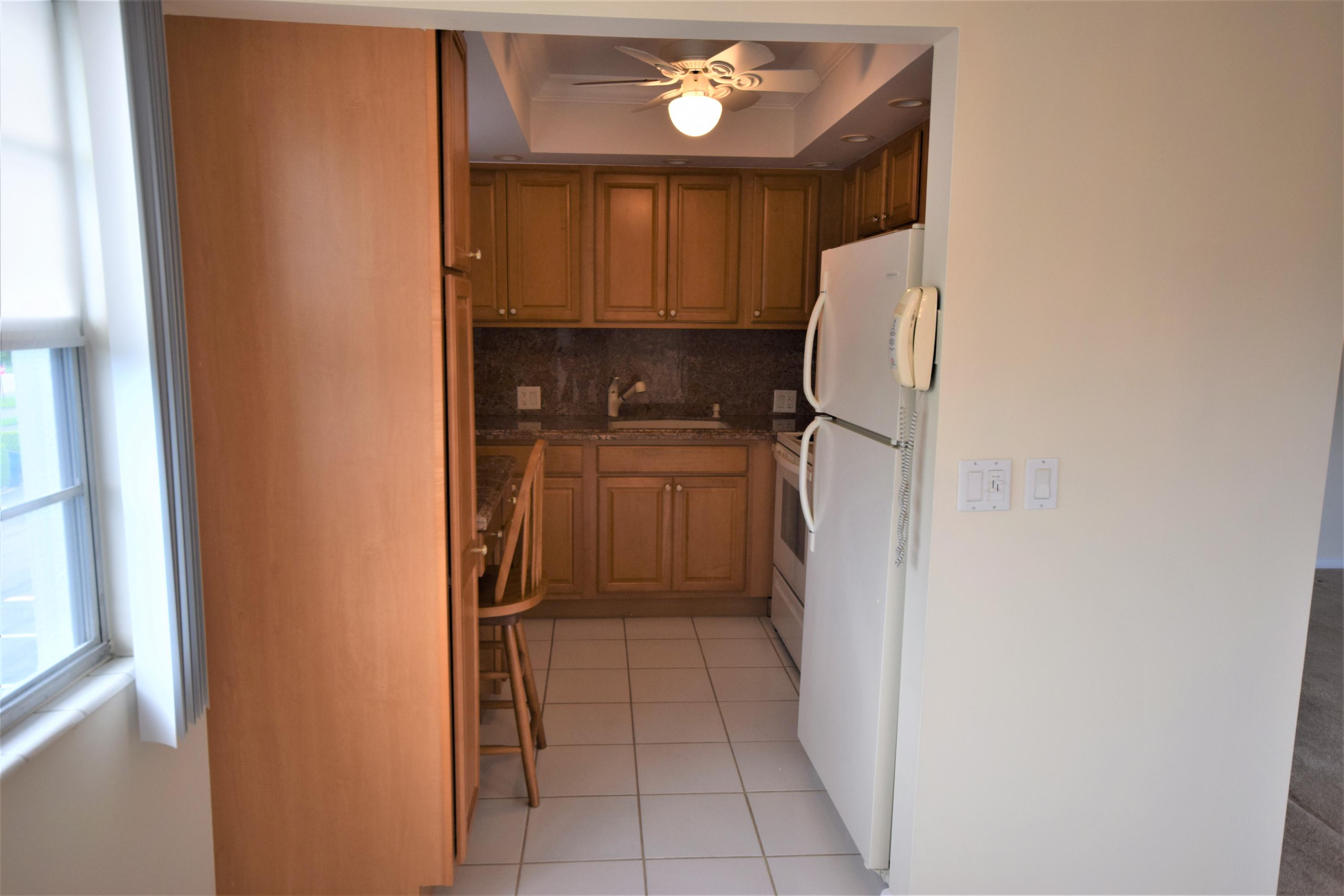 29 Dorset A Boca Raton, FL 33434 - Photo 10 of 22 a kitchen with a refrigerator and a sink