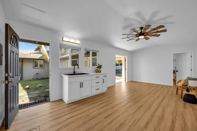 a view of workspace with wooden floor and a ceiling fan