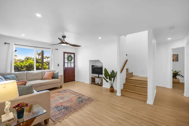 a living room with furniture and a wooden floor