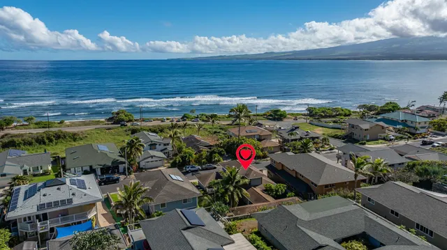 an aerial view of a house with a yard and a fountain