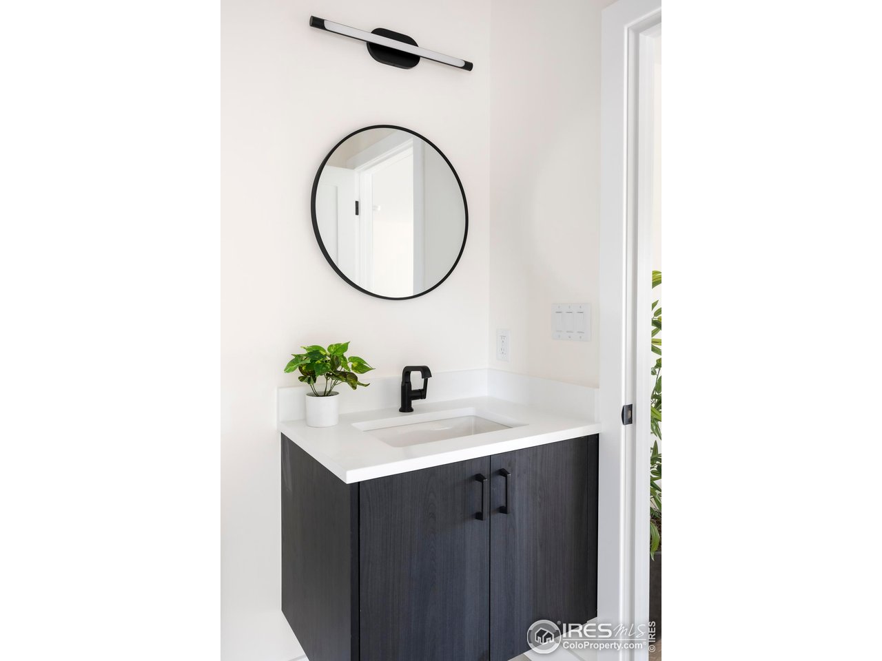 855 Eudora Street Denver, CO 80220 - Photo 31 of 37 a bathroom with a sink and a mirror