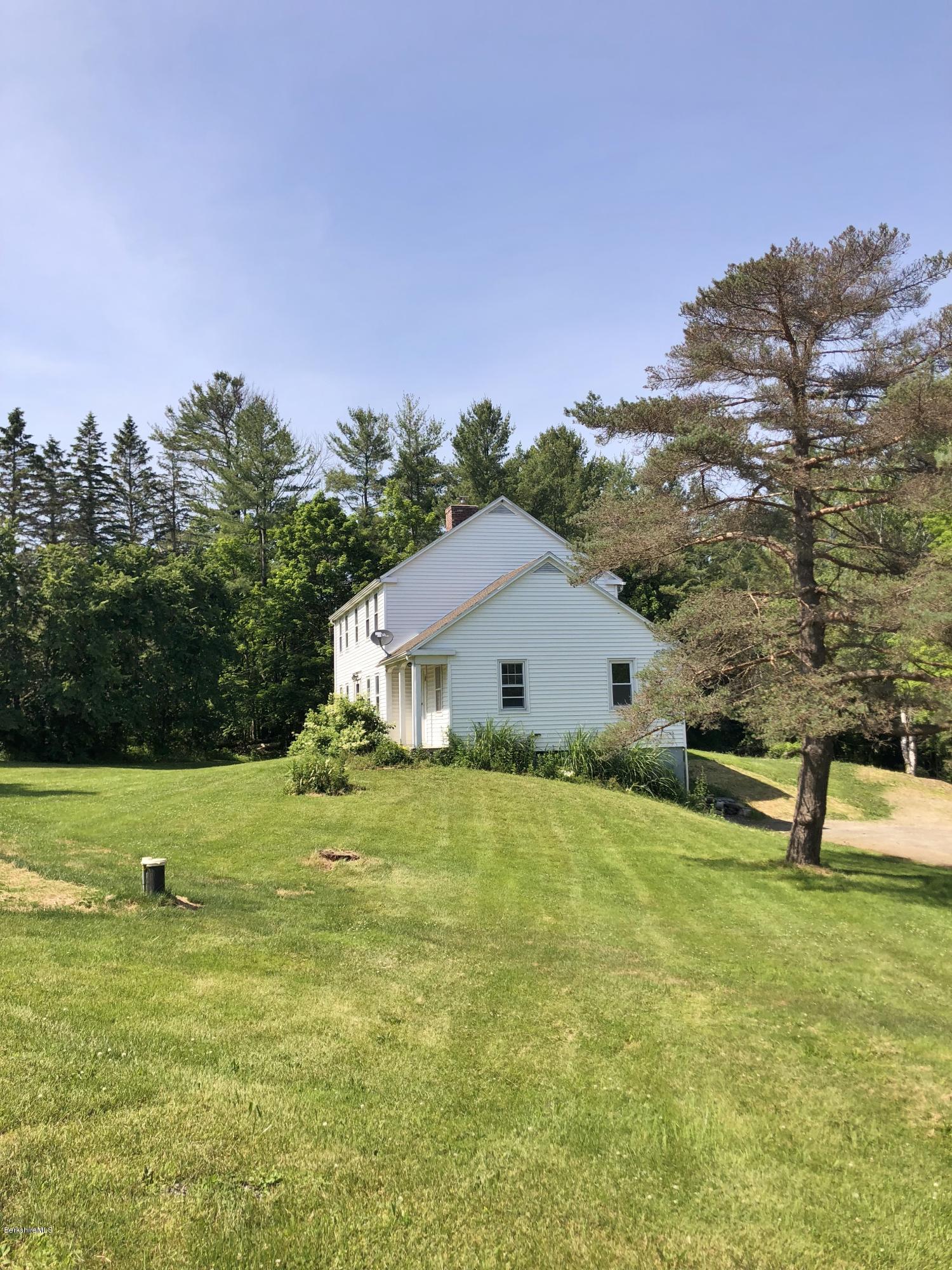 1499 State Road Richmond, MA 01254 - Photo 17 of 25 a backyard of a house with lots of green space and mountain view in the back