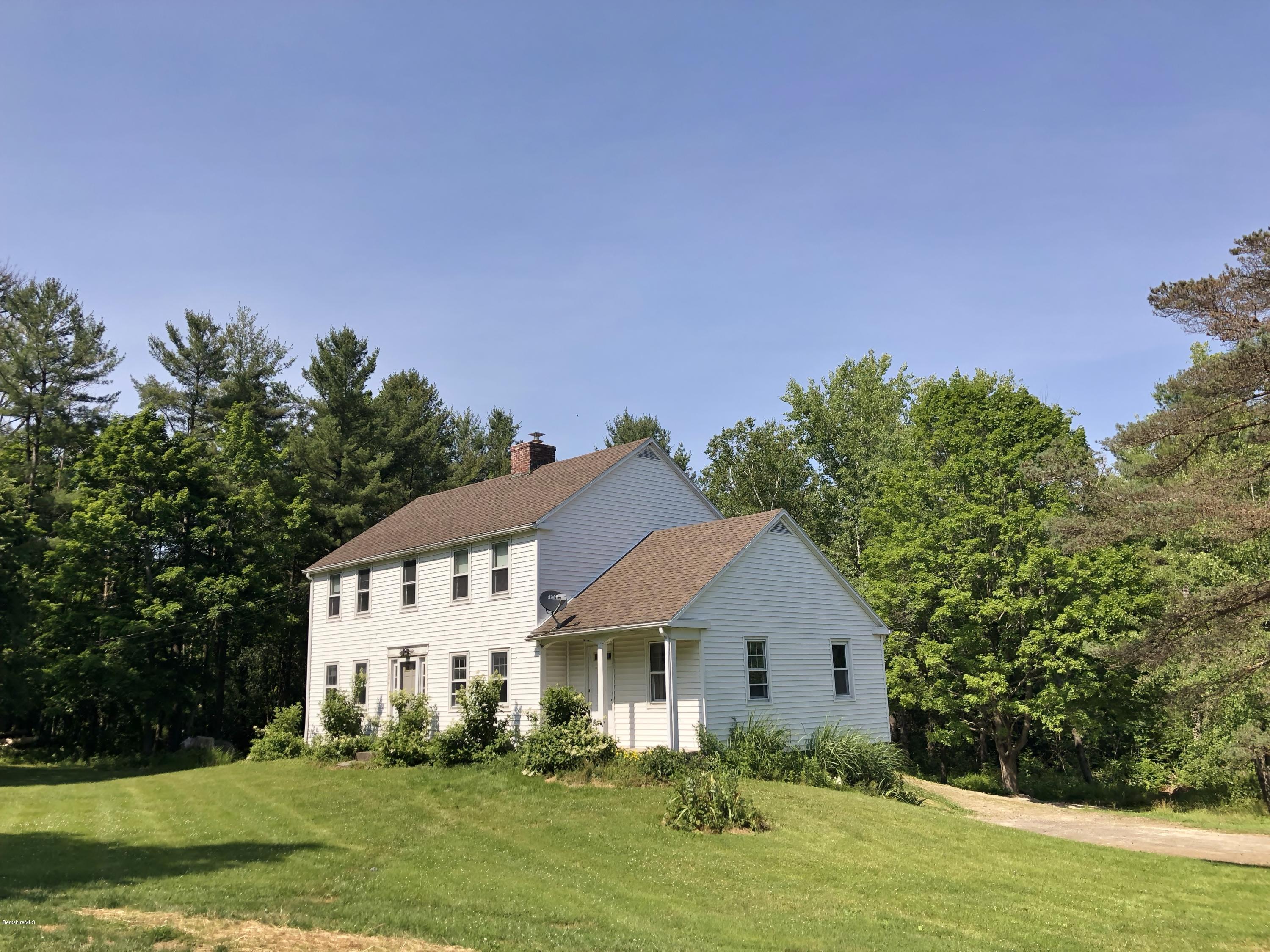 1499 State Road Richmond, MA 01254 - Photo 20 of 25 a front view of a house with a yard