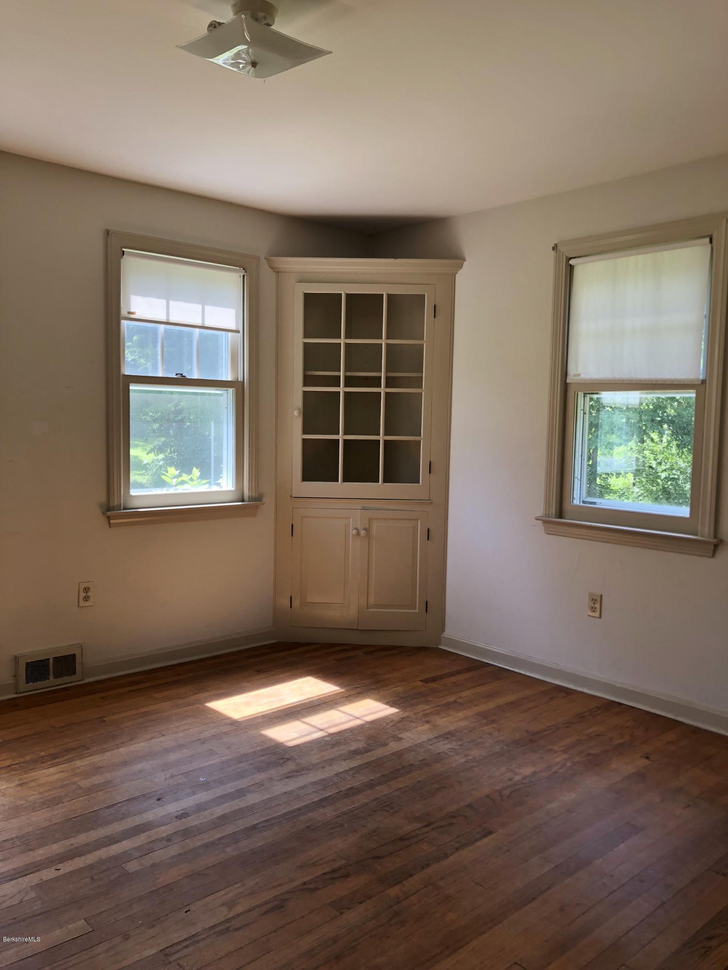 1499 State Road Richmond, MA 01254 - Photo 3 of 25 a view of an empty room with wooden floor and a window