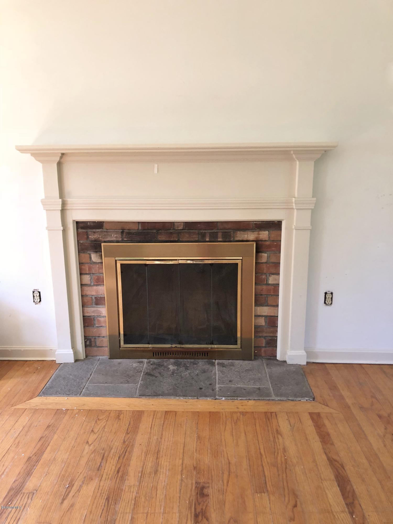 1499 State Road Richmond, MA 01254 - Photo 4 of 25 a view of empty room with wooden floor and a fireplace