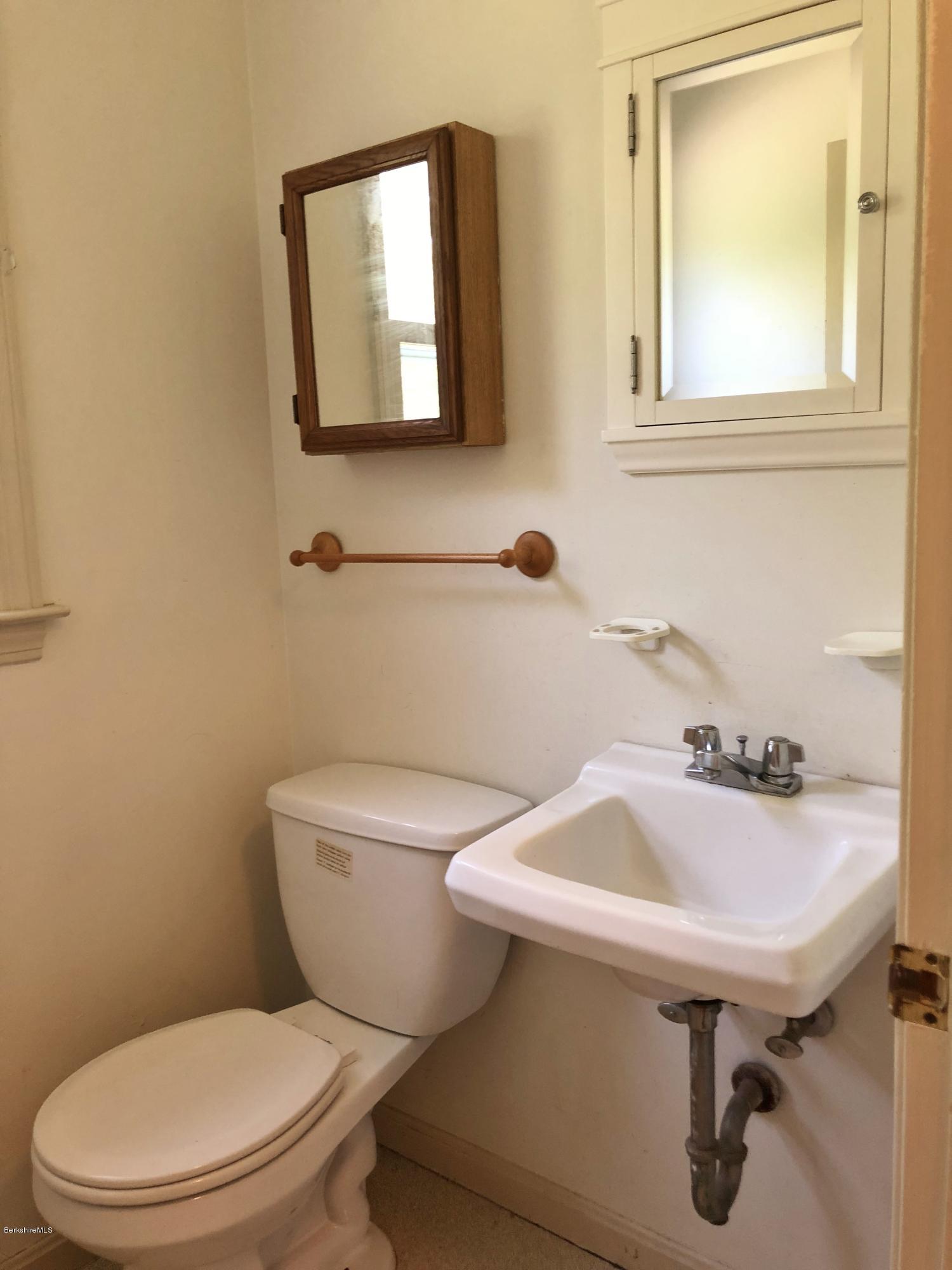 1499 State Road Richmond, MA 01254 - Photo 6 of 25 a white toilet sitting next to a bathroom sink