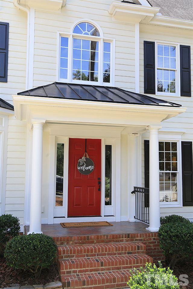 7812 Mayapple Place Raleigh, NC 27613 - Photo 2 of 30 This is a very welcoming porch with tile floor and back railings.