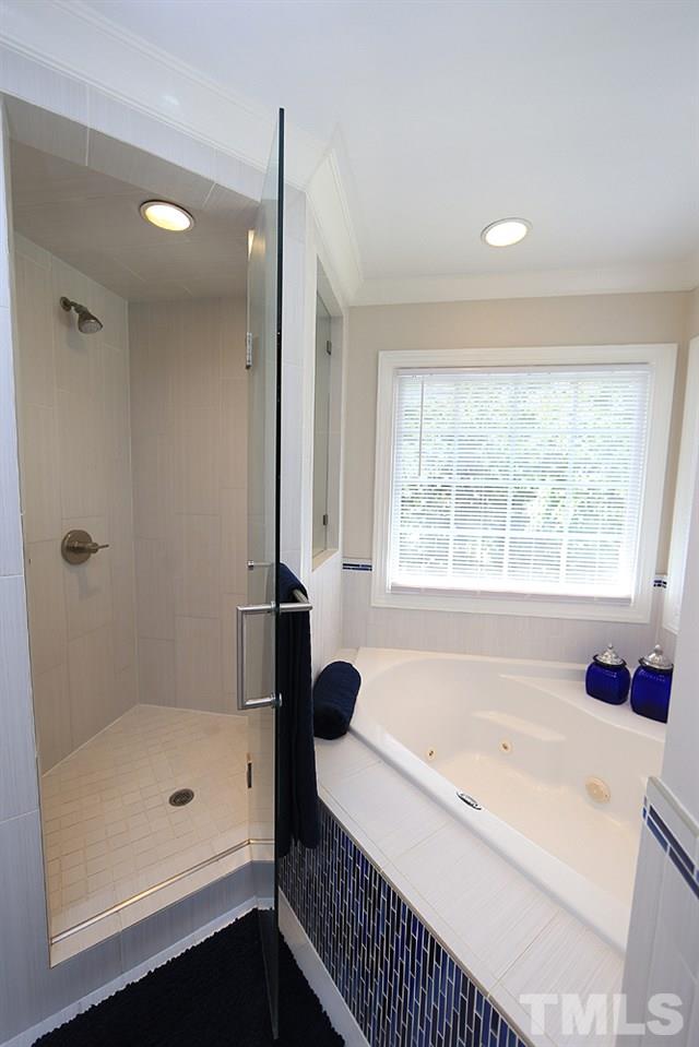 7812 Mayapple Place Raleigh, NC 27613 - Photo 16 of 30 Enjoy the roomy shower or the jetted tub.