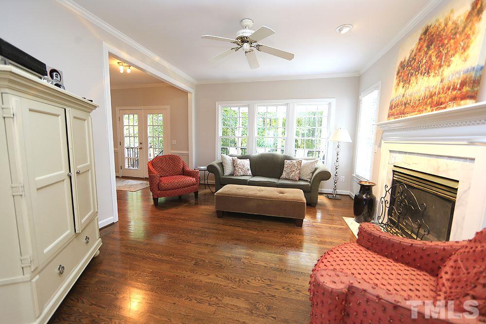 7812 Mayapple Place Raleigh, NC 27613 - Photo 6 of 30 Gas fireplace, lots of light and easy access to the terrific deck.