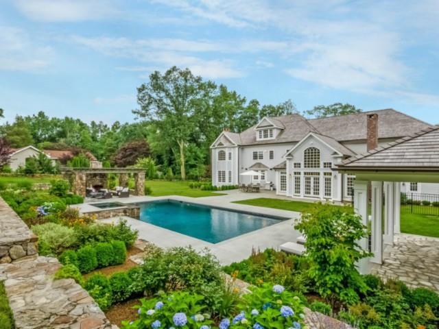 82 Buckingham Ridge Road Wilton, CT 06897 - Photo 1 of 1 a front view of house with yard and swimming pool