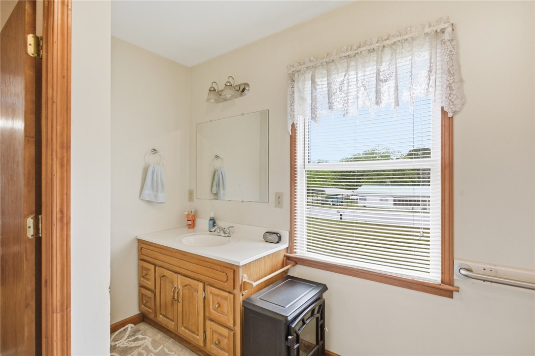 282 West Bennett Road Westminster, SC 29693 - Photo 26 of 42 This bright bathroom features a spacious vanity with ample storage, reflecting natural light from a large window.