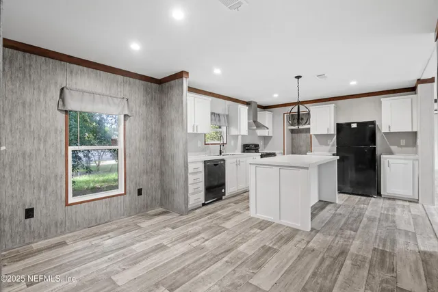 a kitchen with refrigerator cabinets and wooden floor