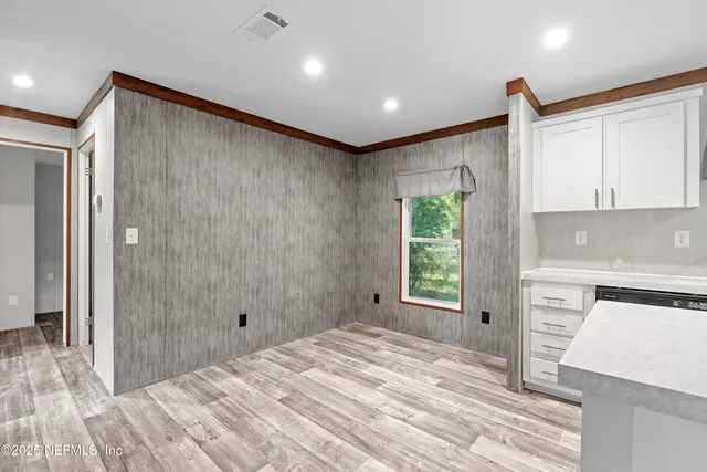 a bathroom with a bathtub and a window