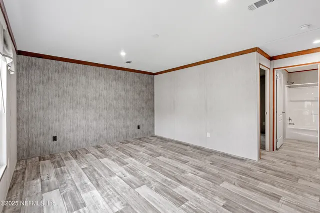 a view of a room with wooden floor