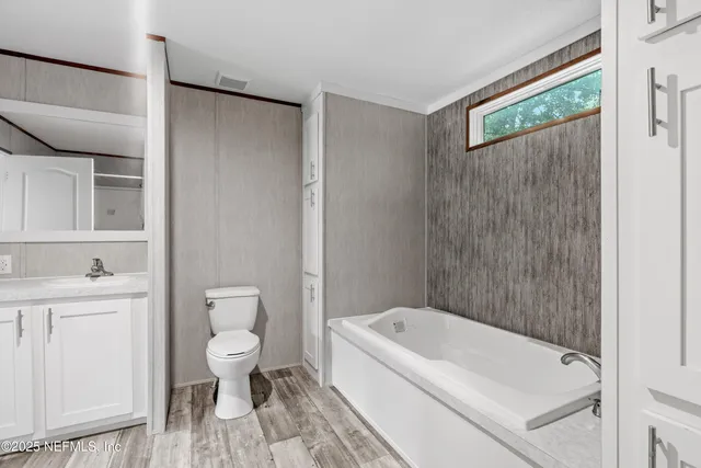 a bathroom with a bathtub and a toilet