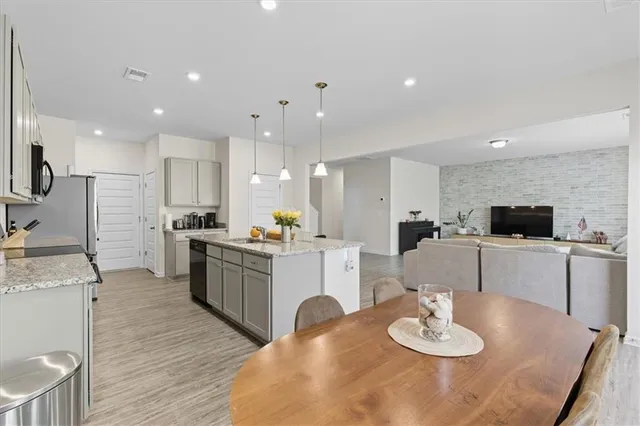 a kitchen with stainless steel appliances kitchen island granite countertop a sink and cabinets
