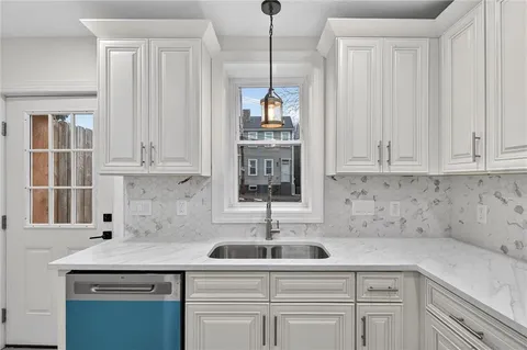 a kitchen with appliances cabinets and a sink