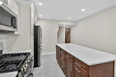 a kitchen with a stove and a refrigerator
