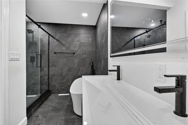 a bathroom with a shower and a sink