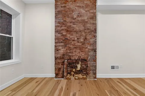 view of a room with wooden floor and a window