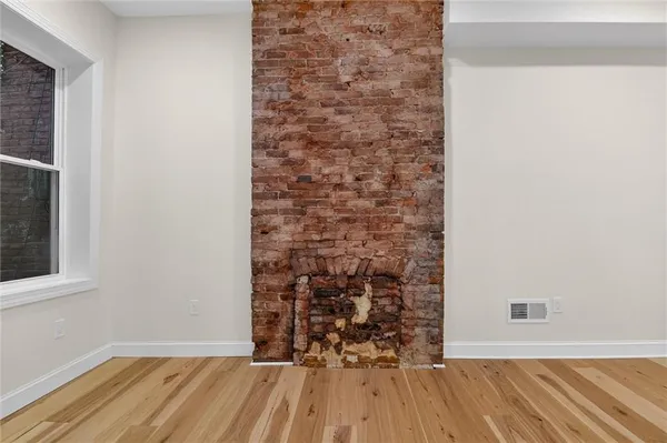 view of a room with wooden floor and a window