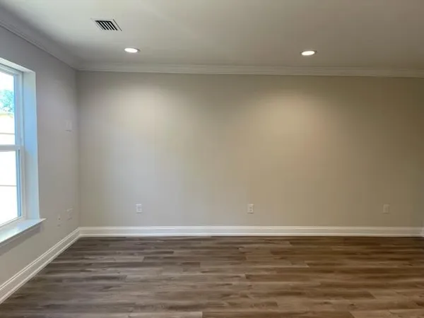 a view of a room with wooden floor and window