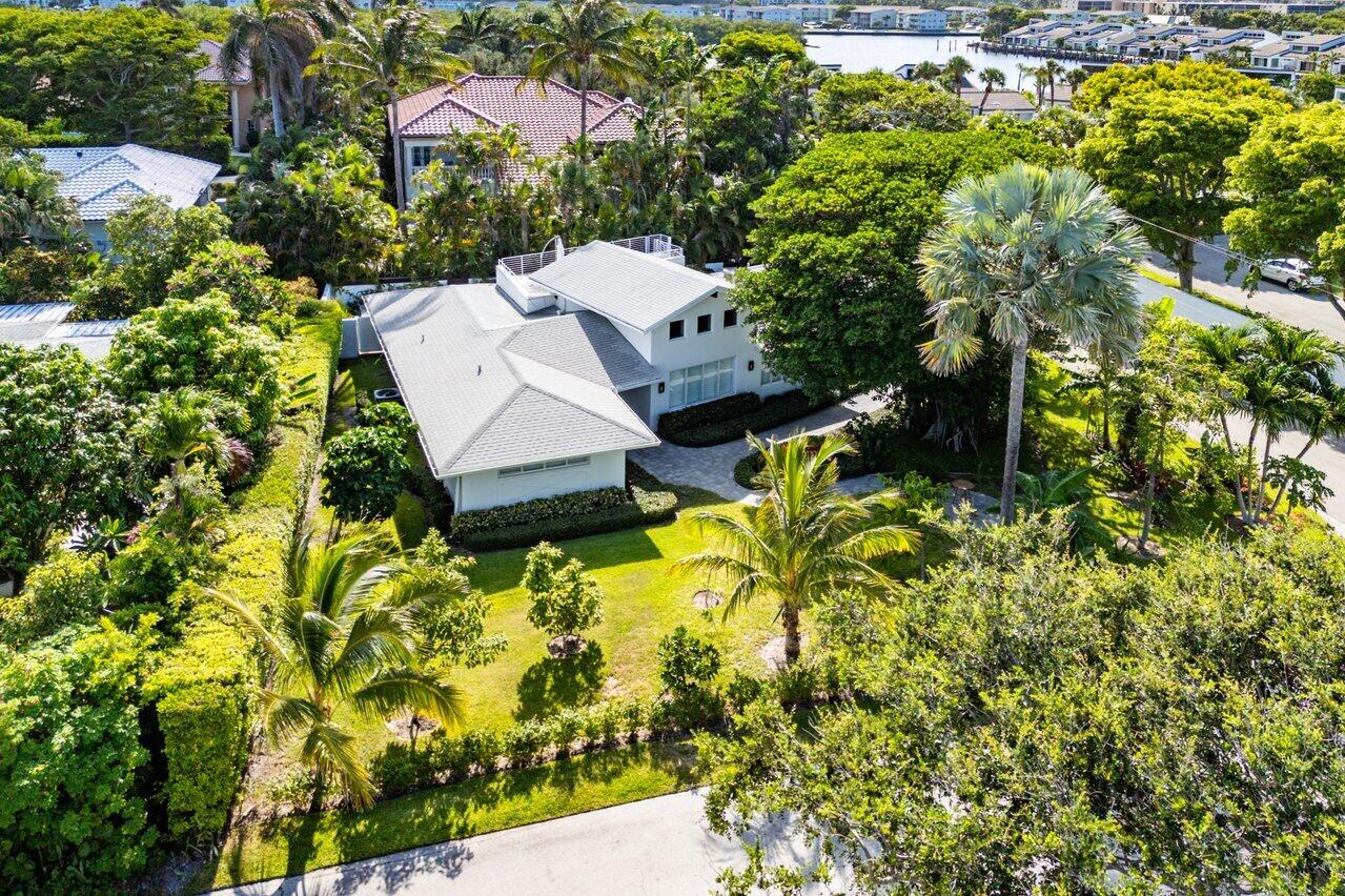 an aerial view of a house with a yard basket ball court and outdoor seating