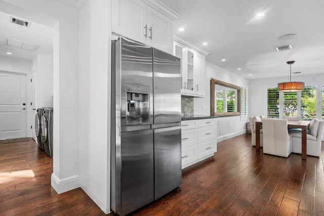 a utility room with granite countertop a sink and a stove top oven