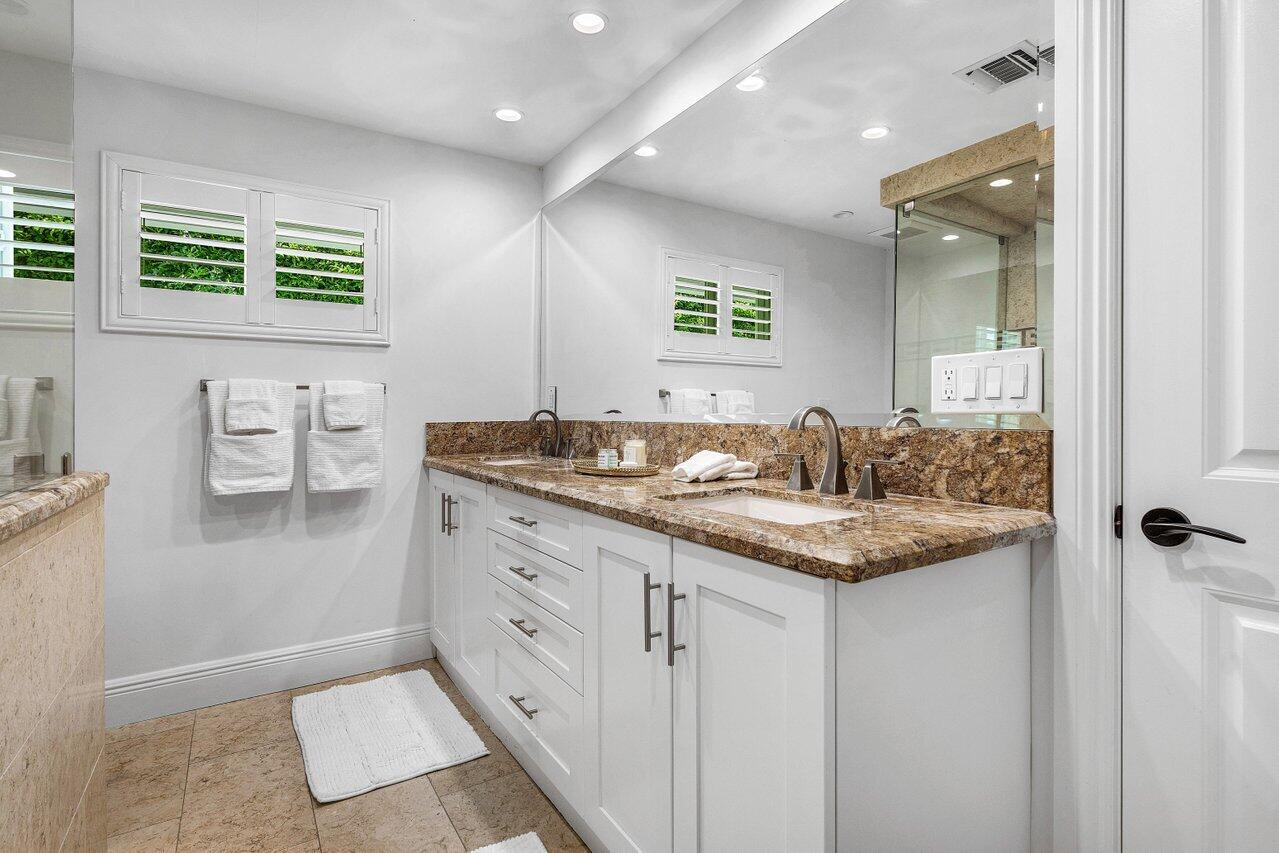 6130 Ridge Lane Ocean Ridge, FL 33435 - Photo 16 of 33 a en suite bathroom with a granite countertop sink and a mirror