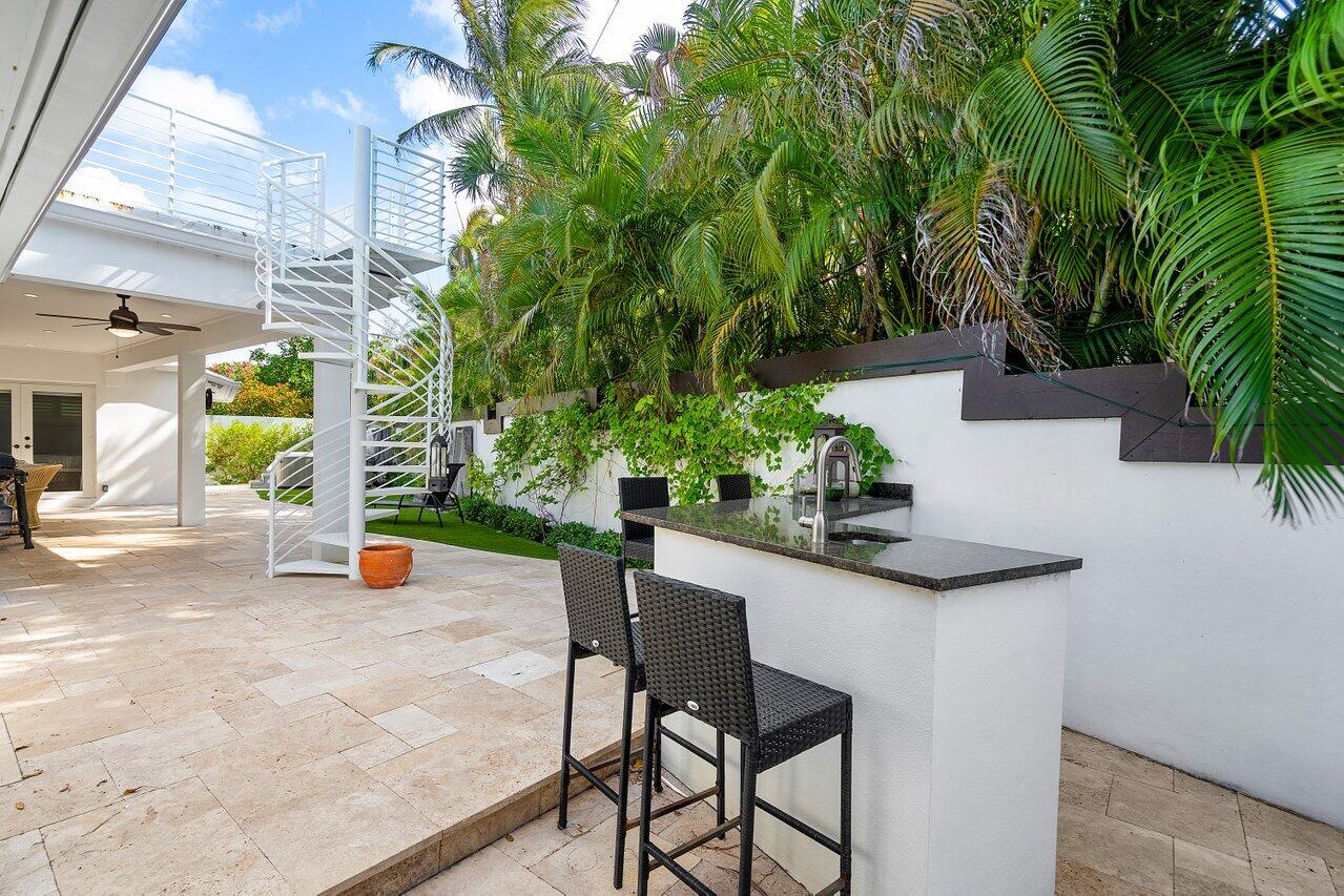 6130 Ridge Lane Ocean Ridge, FL 33435 - Photo 27 of 33 a view of a backyard with plants and a patio